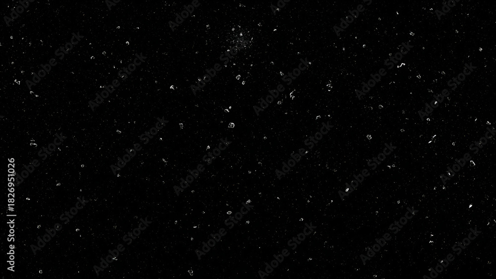 Fototapeta premium Black background with scattered white dust particles and light speckles