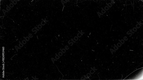 Dark surface with scattered white dust and scratches