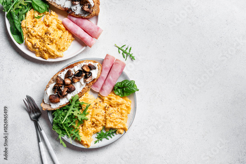 Healthy balanced breakfast with scrambled eggs, sandwich, ham