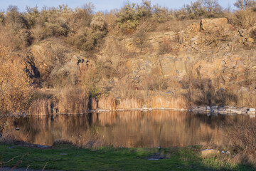 Plexiglas schilderij Reflectie Verlaten granietgroeve met herfstbos spiegeling  © Olha
