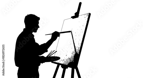 Silhouette of a male artist painting on a canvas with a brush and easel in a studio setting