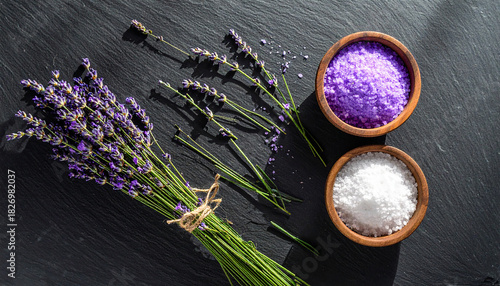 Lavender Bundles and Bowls of Purple and White Bath Salts on Dark Surface flowers herbs