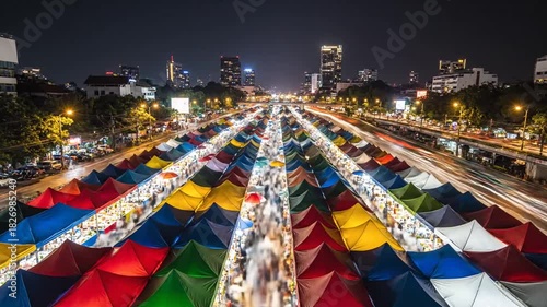 Aerial View of Night Market with Colorful Tents in Bangkok Thailand, long exposure shot, city skyline in Background, Warm Lighting Style and Nighttime Atmosphere