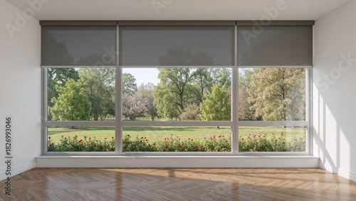 Empty room with large window and blinds, overlooking a scenic outdoor view of trees and a garden. Modern interior design. Natural light and open space. The concept of indoor-outdoor connection.