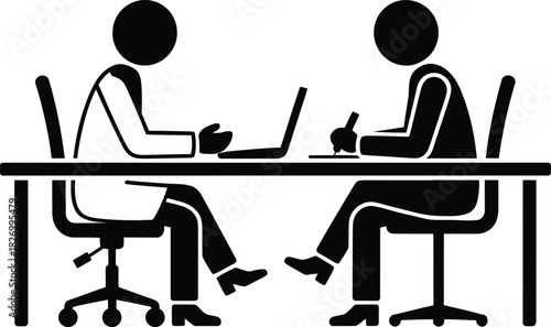Two business people working at desk with laptop and paperwork
