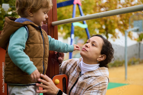 Mother And Child On Playground Laughing On An Autumn Day In The Park