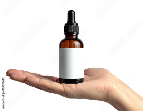 Dropper bottle held in hand on black background
