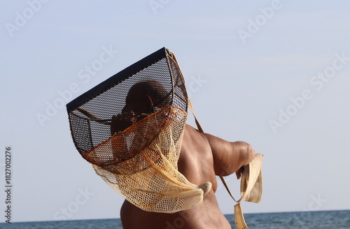 A fisherman using a surfclam scoop/net