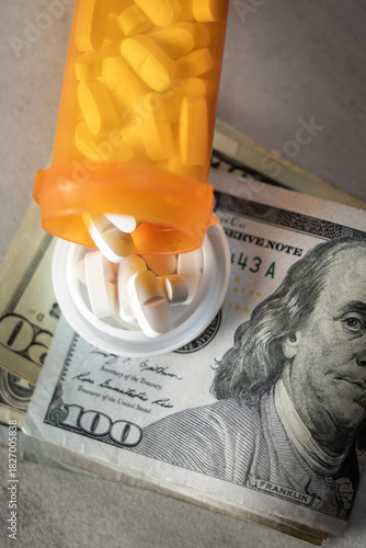A visually impactful shot featuring prescription pill bottles and scattered US dollar bills (cash). This image symbolizes the high cost and financial burden of medication and the debt caused by health