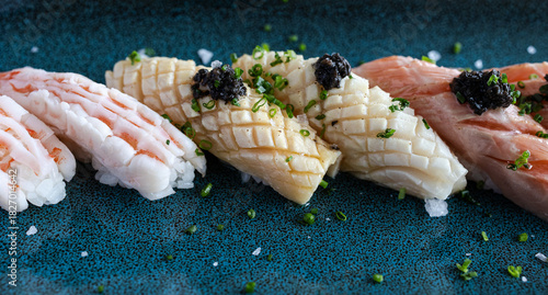 Nigiri sushi platter featuring shrimp, squid, tuna, and caviar