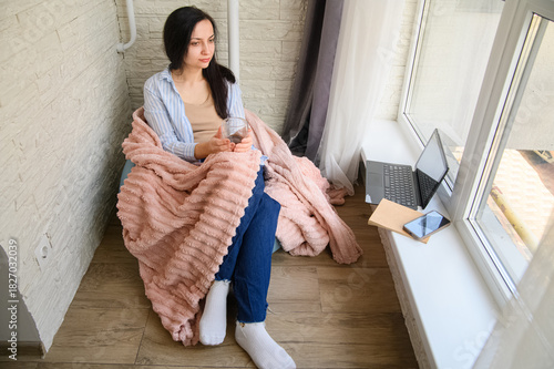 Cozy Home Lifestyle: Woman Reading and Relaxing by the Window