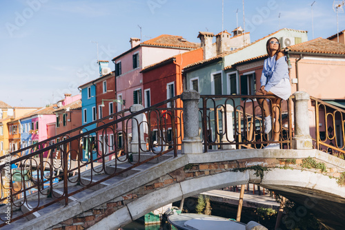 Woman traveling Burano island enjoying Venice architecture