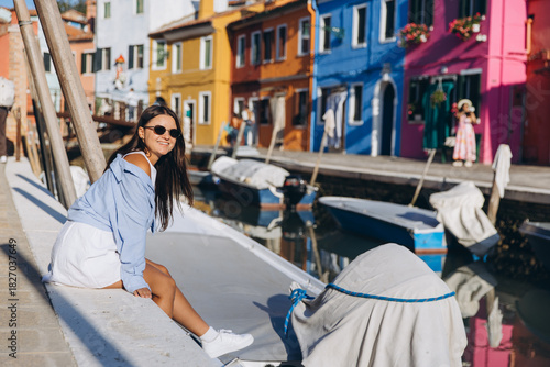 Young woman enjoying travel in colorful Burano island