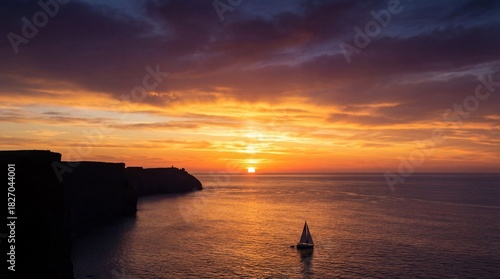 Vibrant sunset over calm ocean waters with a lone sailboat and rocky coastline