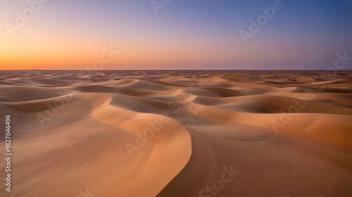 Fototapeta Naklejka Na Ścianę i Meble -  Endless desert landscape with sand dunes under colorful sunset sky panoramic nature scenery of arid environment travel destination and outdoor adventure
