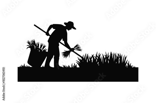 Farmer silhouette harvesting crops in a field