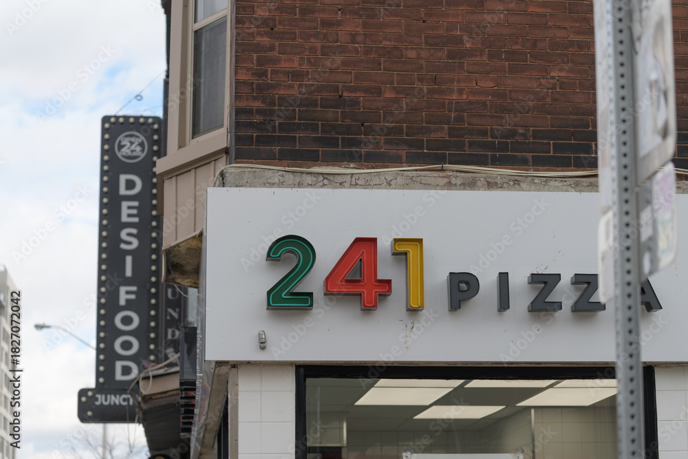 Fototapeta premium exterior building side and sign of 241 Pizza located at 1055 Bloor St W, Toronto (Desi Food sign)