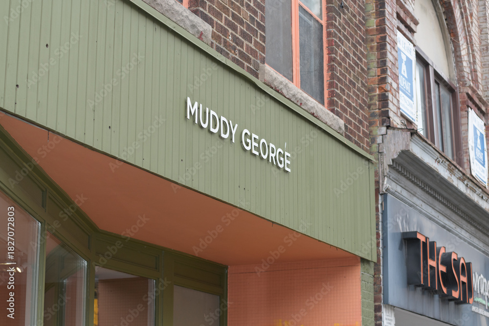 Fototapeta premium exterior building facade and sign of Muddy George, a men's clothing store, located at 973 Bloor St W, Toronto
