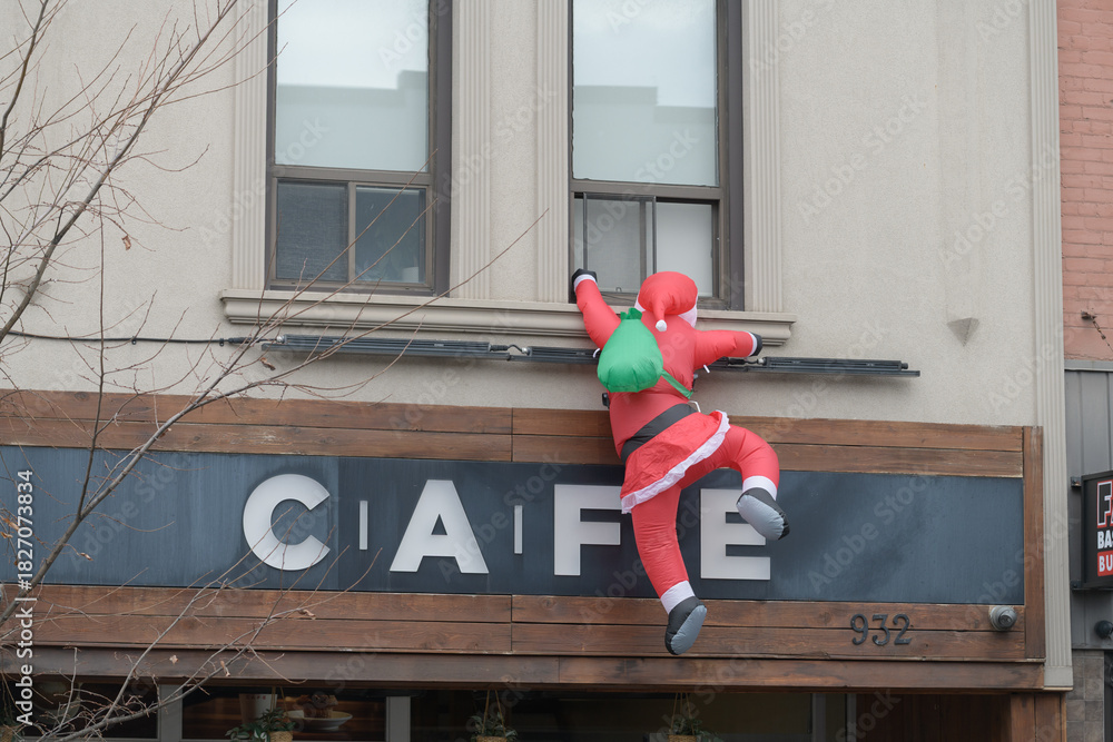 Fototapeta premium holiday Santa inflatable outside CAFE Dispensary, a cannabis store, located at 932 Bloor St W, Toronto