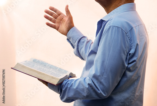 A man with a bible preaches
