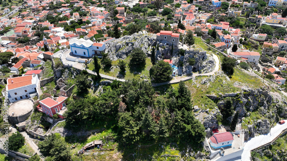 Fototapeta premium Aerial drone photo of iconic castle of Symi island built uphill overlooking main town and Yalos, Dodecanese, Greece