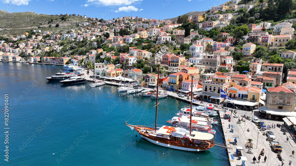 Fototapeta premium Aerial drone photo of picturesque seaside main town and port of Yialos of Symi island with colorful neoclassical houses and traditional character, Dodecanese, Greece