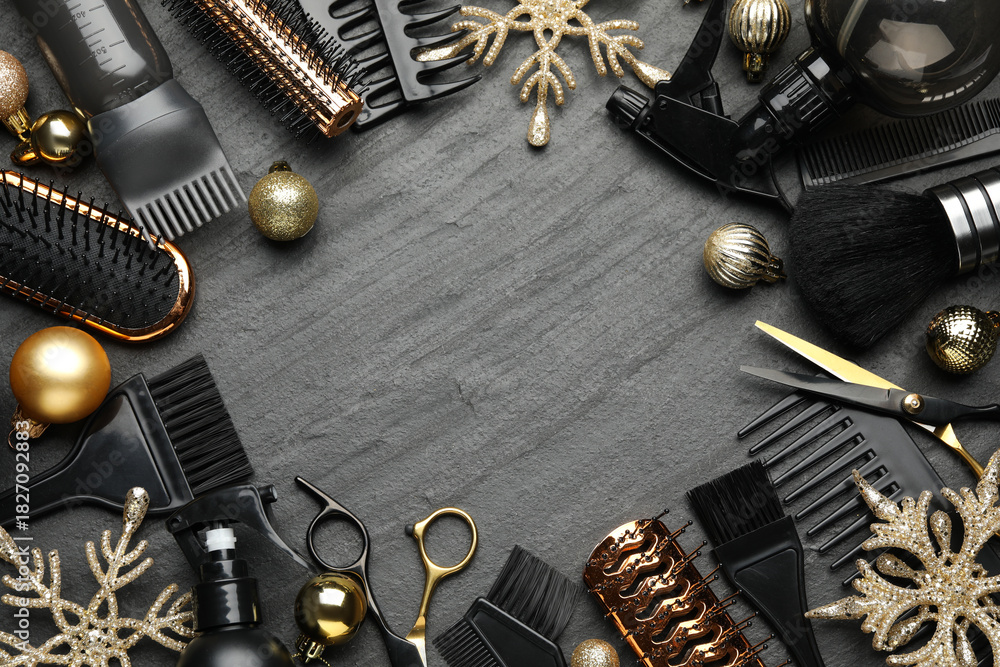 Naklejka premium Hairdresser's tools and Christmas decor on black table, flat lay. Space for text