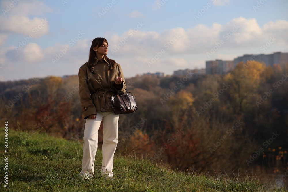 Fototapeta premium Woman enjoying a sunny day in a natural landscape