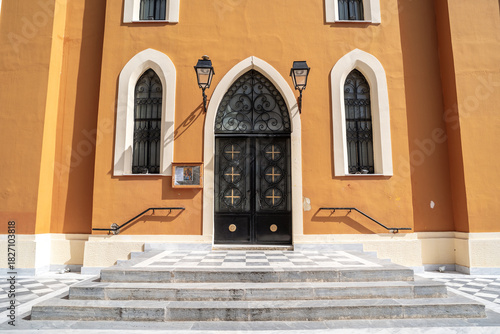 Entrance doors of Agia Kyriaki Church in Pyrgos, Greece, captured on a sunny day