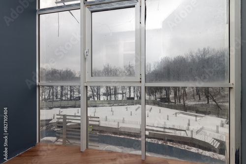 Apartment interior window view overlooking winter construction site