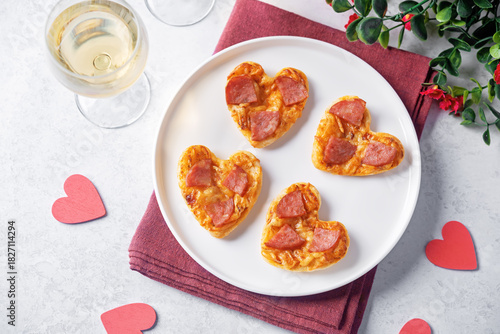Pizza mini with salami in the form of hearts for Valentine's day holiday on a white background