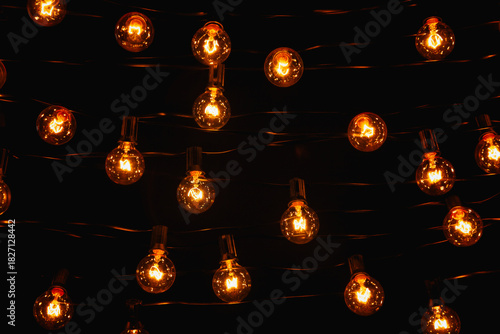 Background - electric garland with incandescent bulbs, yellow warm light