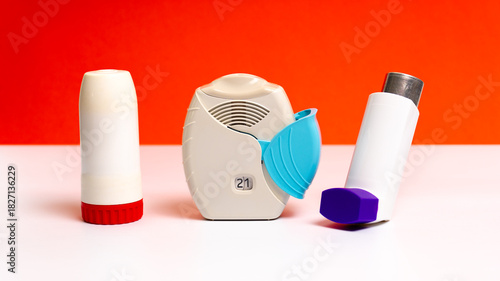 Set of asthma inhalers for asthma and COPD patients. Bronchodilator medicine with salbutamol for patients with asthma, allergy and Chronic Obstructive Pulmonary Diseaseon on orange background.