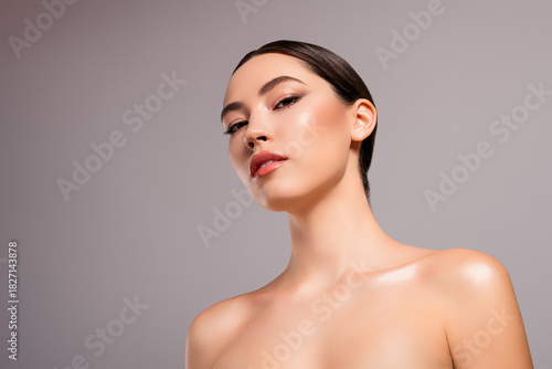 Fotografija Elegant young woman with flawless skin and sleek hairstyle showcasing beauty and
