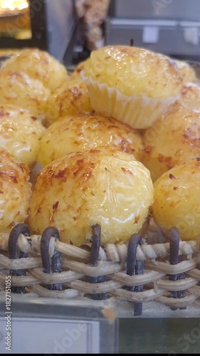 Delicious queijadinhas, traditional Brazilian sweet, in a Brazilian bakery_vertical.