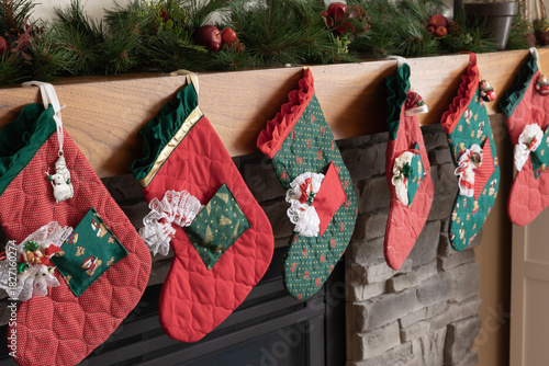 Картината върху платно Christmas stockings hung on a mantle of a fireplace