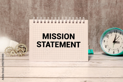 MISSION STATEMENT is written on a wooden blocks on a chart background.