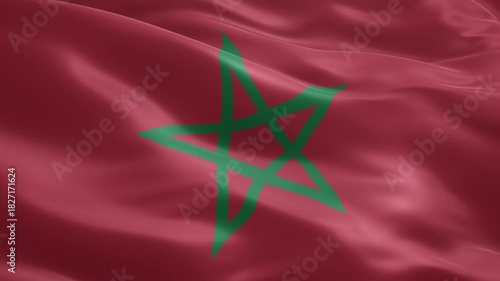Waving national flag of morocco displaying its iconic red field and green pentagram, symbolizing the rich history, culture, and sovereignty of the north african nation.