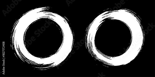 Two bold black ink circles painted with dynamic brush strokes, minimalist Japanese sumi-e style, clean background.