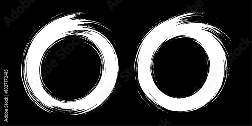 Two bold black ink circles painted with dynamic brush strokes, minimalist Japanese sumi-e style, clean background.