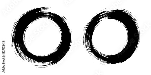 Two bold black ink circles painted with dynamic brush strokes, minimalist Japanese sumi-e style, clean background.