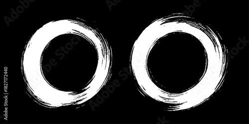 Two bold black ink circles painted with dynamic brush strokes, minimalist Japanese sumi-e style, clean background.