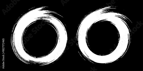 Two bold black ink circles painted with dynamic brush strokes, minimalist Japanese sumi-e style, clean background.