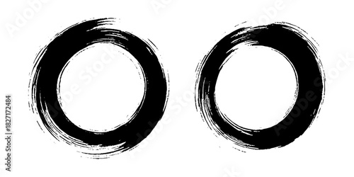 Two bold black ink circles painted with dynamic brush strokes, minimalist Japanese sumi-e style, clean background.