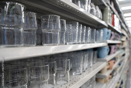 Close up of clear drinking glasses on store shelf.