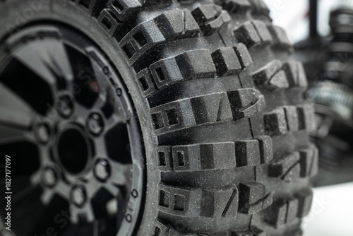 Close-up of the tread of a car tire designed for driving on uneven road surfaces.