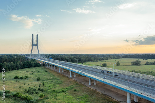 White cable-stayed bridge and highway at sunset. Redzinsky Bridge, Wroclaw, Poland