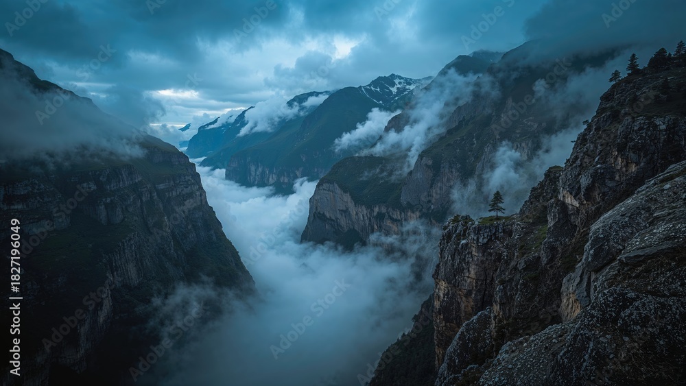 Obraz premium Mountain landscape with clouds and mist surrounding the cliffs and valley. Nature and scenery, foggy weather, and rugged terrain.