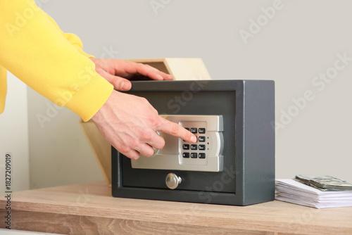 Man opening safe on shelf a...