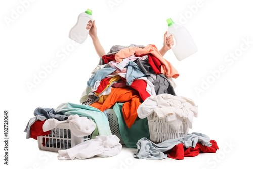 Foto Young woman holding laundry detergent bottles behind huge pile of dirty clothes